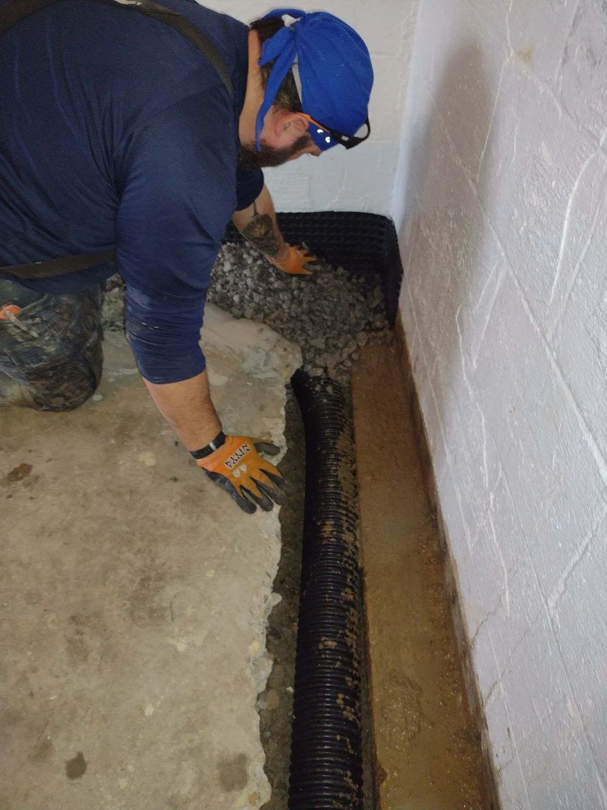 AquaGuard employee skillfully waterproofing a basement